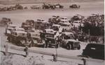 Pole-sitter Fred Thompson leads the field of 104 cars on the pace lap moments before the start of the 1954 Modified race...
