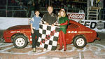 Richard Newton takes a Mini stock win in 1990 driving his "Sweet Pea Capri."