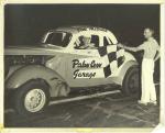 Starter Stan Kross presents the checker to a happy Jim McGuirk. (Courtesy DonnaGail McNamara)