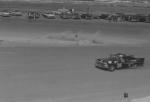 ...then disappears over the bank as eventual winner Curtis Turner passes...
