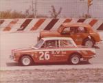 Cortina of Woody Tinnety #26 races against the MGB-powered Datsun of Phil Greenwood...