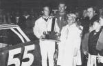 Singer Pat Boone joins Tiny Lund in victory lane after Tiny won the 200 lap Jacksonville Speedway championship in Nov. 1967..