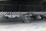 1975 Cyclone action - Randy Barnwell #5 misses a spinning car as Joey Burns #27 and Jim Tuning #38 avoid...