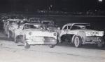 Figure-8 cars line up to start in the early-1960s with a pair of Buicks on row one...