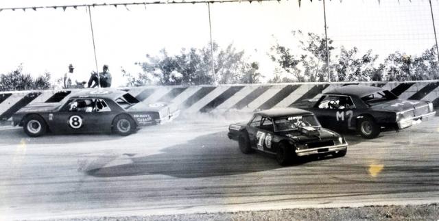 Bud Johnson drives away from a spinning Buddy Griffin as Joe Edwards has nowhere to go...