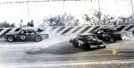 Bud Johnson drives away from a spinning Buddy Griffin as Joe Edwards has nowhere to go...