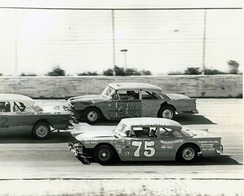Butch Mock #75 and Roger Boone try to split another competitor...