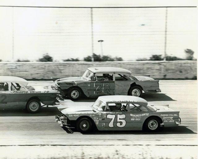 Butch Mock #75 and Roger Boone try to split another competitor...