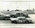 Butch Mock #75 and Roger Boone try to split another competitor...