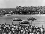 Pat Kirkwood (99) and Fonty Flock (14) split Buck Baker's stalled car - 1952 (State Archives of Florida)