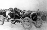 Men in a Buick racing automobile just past the turn of the century...