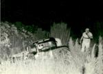 Bob Luscomb surveys the damage after going  off a turn in 1961 (Luscomb Collection)