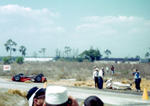 1956 - Marshalls get set to put an injured Carlos Menditeguy on a stretcher after he crashed his Maserati (Courtesy barcboys.com