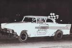 Tommy Holmes grabs a checker in Al Stageberg's LM Plymouth - 1962 (Jim Fenton Collection)