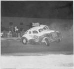 Sam DiRusso loops Johnny Merendino's coupe in the early 50s. Right side numbers were done in neon!!
